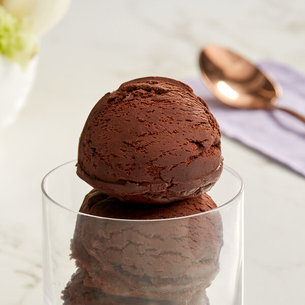 A close-up of a scoop of Oringer brownie batter ice cream in a glass.