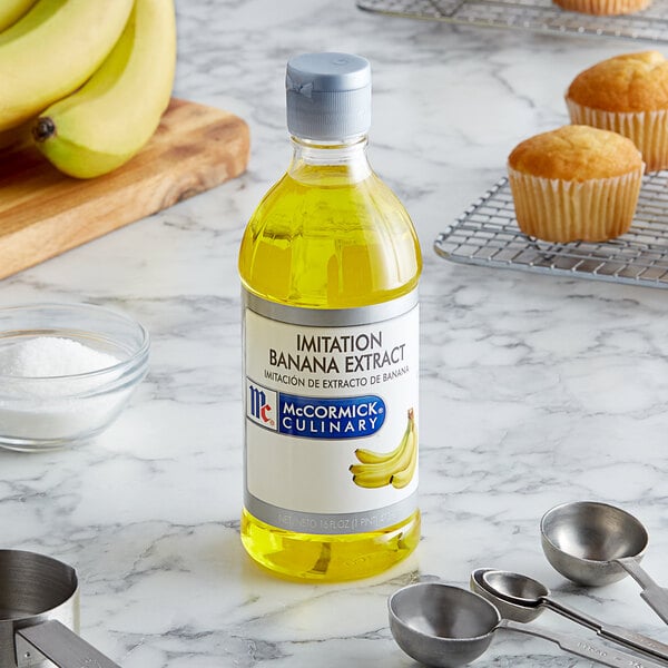 A bottle of McCormick Culinary Imitation Banana Extract on a counter.
