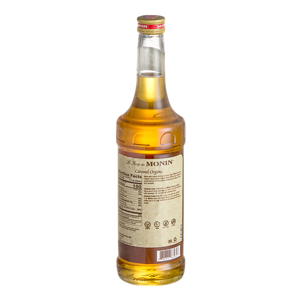 A 750 mL bottle of Monin Organic Caramel Flavoring Syrup.