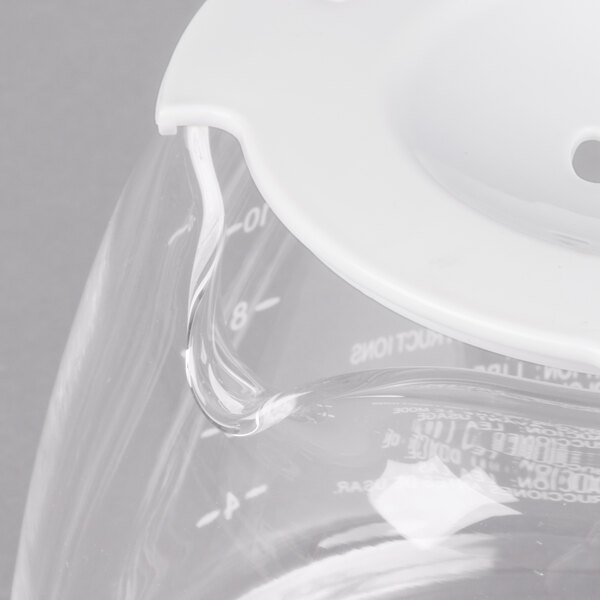 A clear glass coffee pot with a white lid.