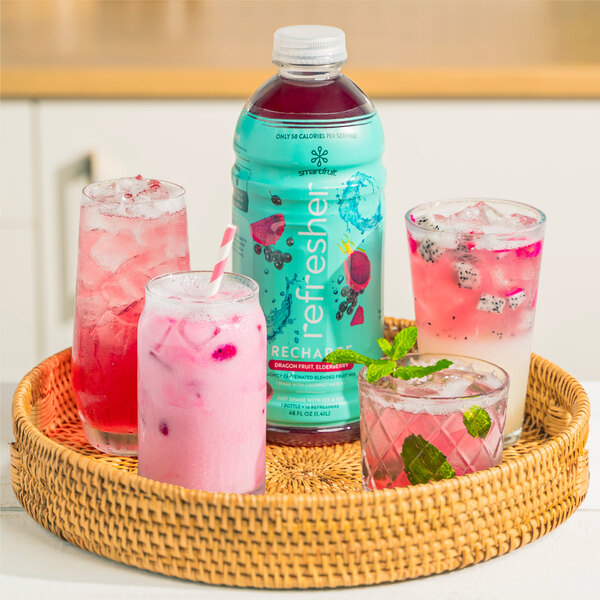 A basket with a jar of Smartfruit Recharge Dragon Fruit and Elderberry refresher and a bottle of Smartfruit Recharge liquid on a table.