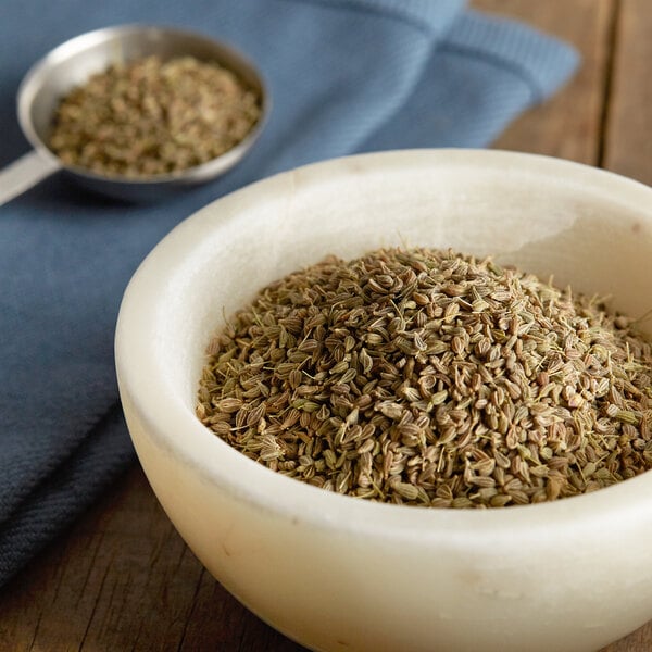 A bowl of Regal anise seeds on a table.