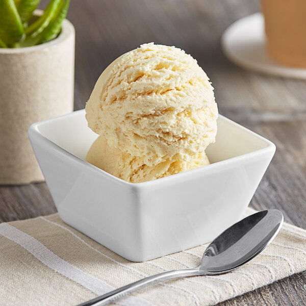 A bowl of I. Rice Cake Batter ice cream with a spoon.
