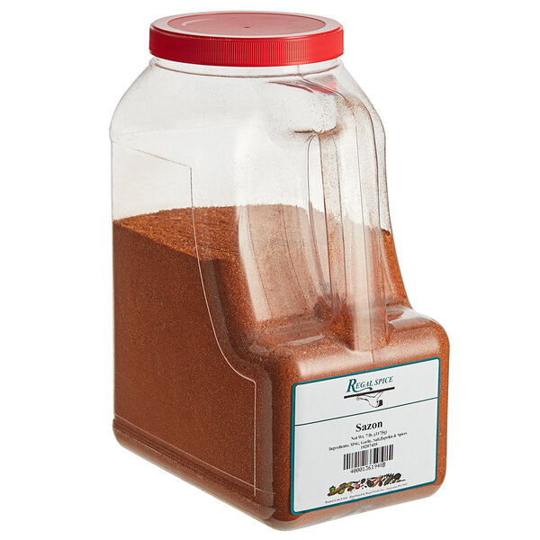 A plastic container of Regal Sazon seasoning with a red lid.