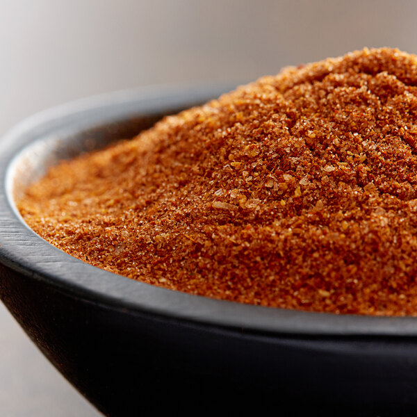 A bowl of red powder on a table.