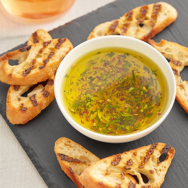 A black tray with a bowl of Goya Extra Virgin Olive Oil and bread slices.
