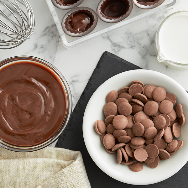 A bowl of Cacao Barry milk chocolate pistoles.