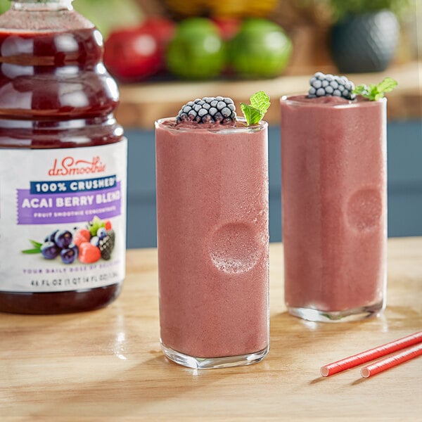 Two glasses of Dr. Smoothie Acai Berry smoothie with berries on top.