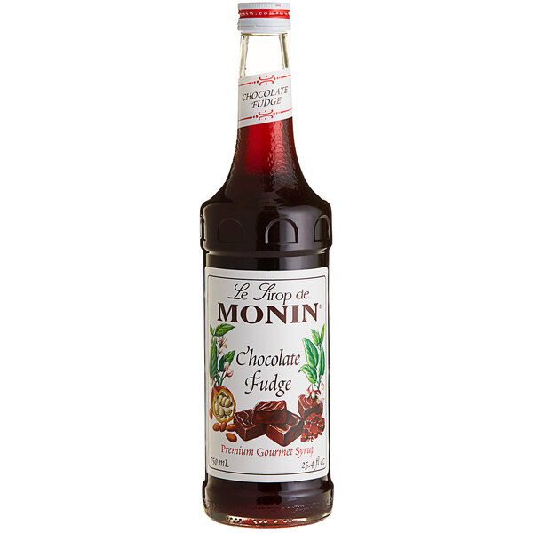 A bottle of Monin chocolate fudge syrup with a white label.
