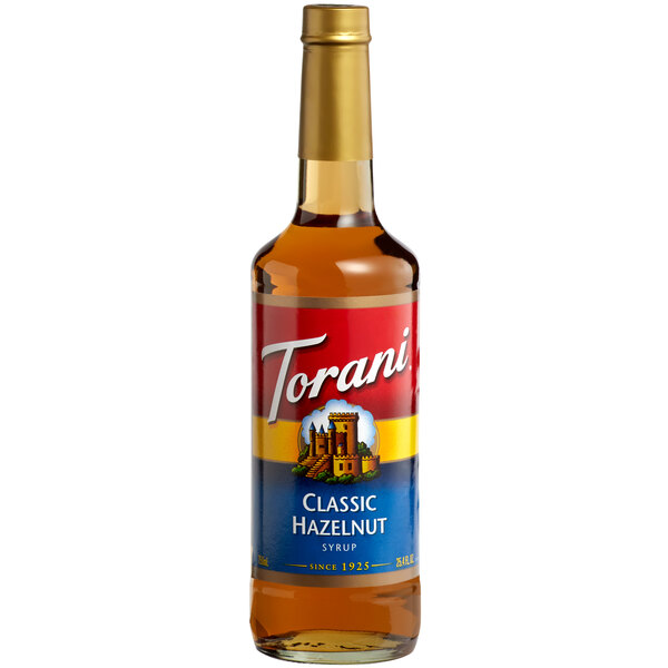 A Torani Classic Hazelnut flavoring syrup glass bottle with a label.