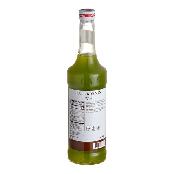 A green bottle of Monin kiwi syrup.