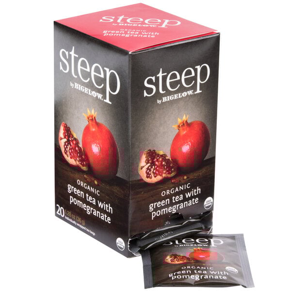 A box of Steep by Bigelow Organic Green Tea with Pomegranate Tea Bags on a table.