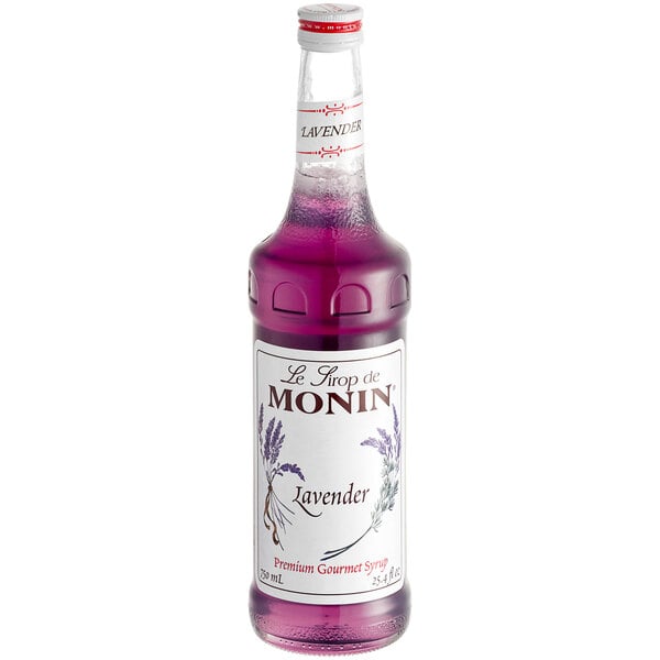 A bottle of Monin lavender flavoring syrup with a white label.
