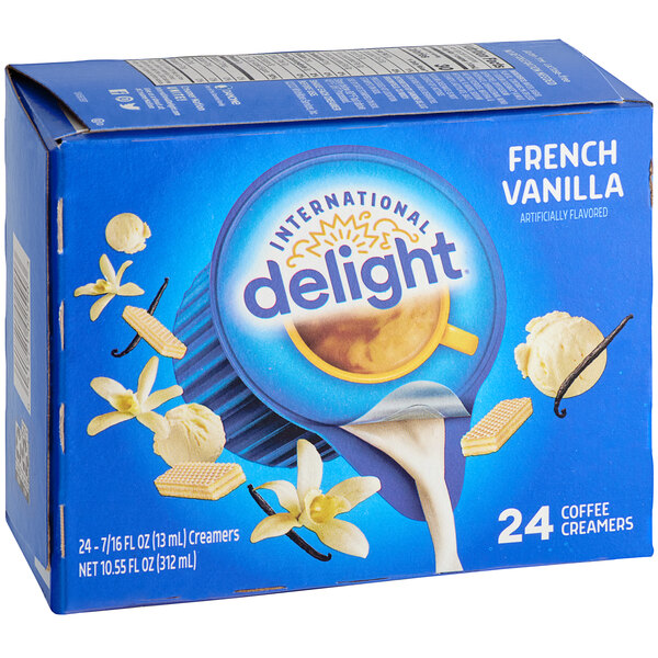 A blue box of International Delight French Vanilla Single Serve Non-Dairy Creamer on a counter.