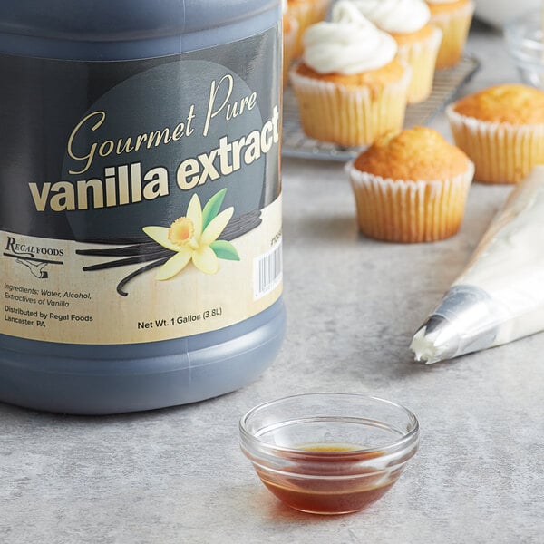 A bottle of Regal Gourmet Pure Vanilla Extract next to a cupcake.