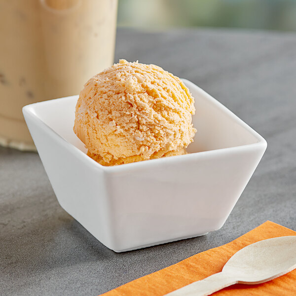 A scoop of Oringer Orange Pineapple ice cream in a white bowl.