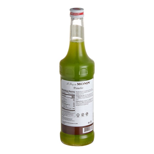 A green Monin bottle of liquid with a white label.