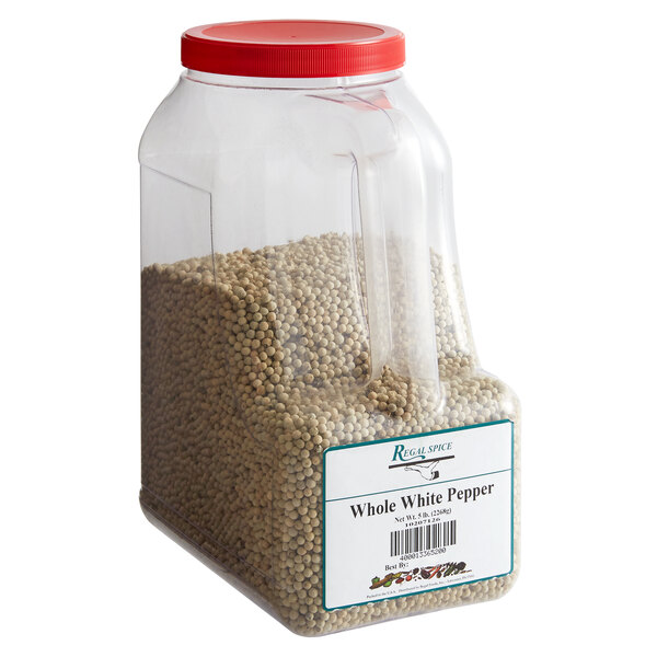 A plastic container of Regal Whole White Peppercorn with a label.