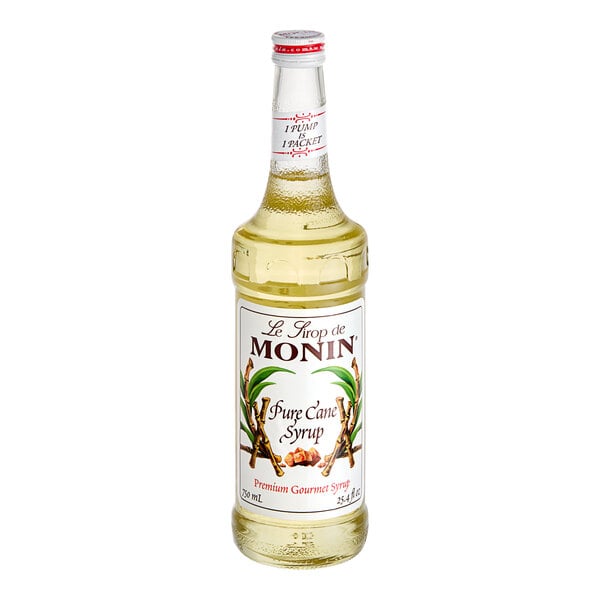 A Monin Premium Pure Cane Syrup bottle with a white label.