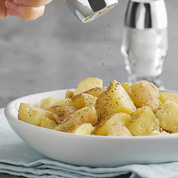 A bowl of potatoes with Regal Table Grind Ground Black Pepper.