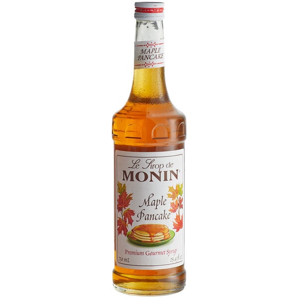 A bottle of Monin maple pancake flavoring syrup with a white label.
