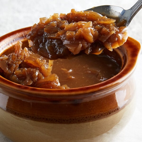 A spoonful of Regal Granulated Onion in a bowl.