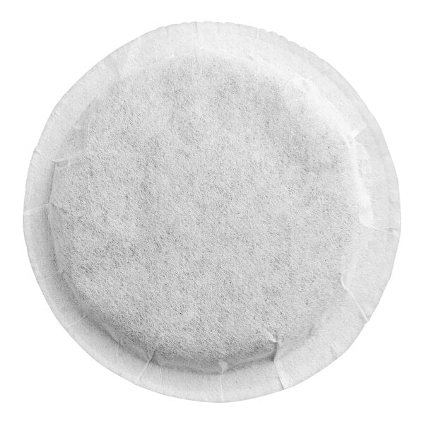 A round, white, mesh-like tea pod with a sealed edge, viewed from above.