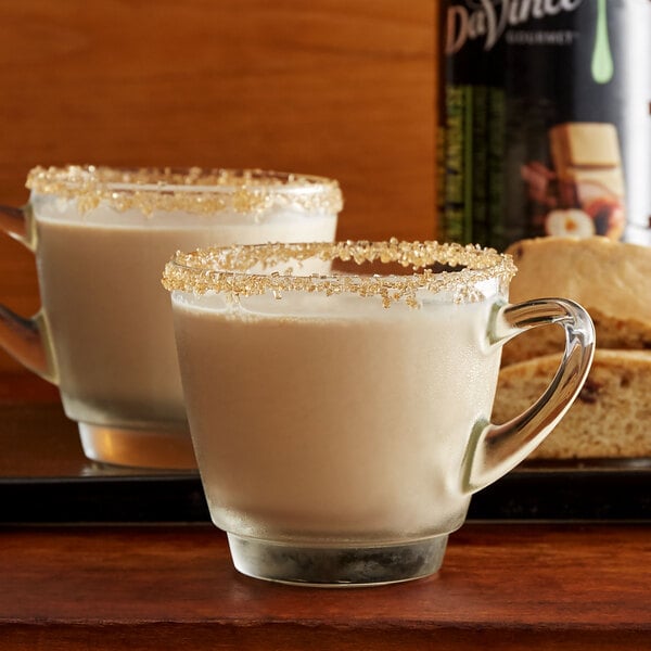 Two glass mugs of white liquid with brown sugar rims using DaVinci Gourmet Sugar Free Irish Cream Flavoring Syrup.