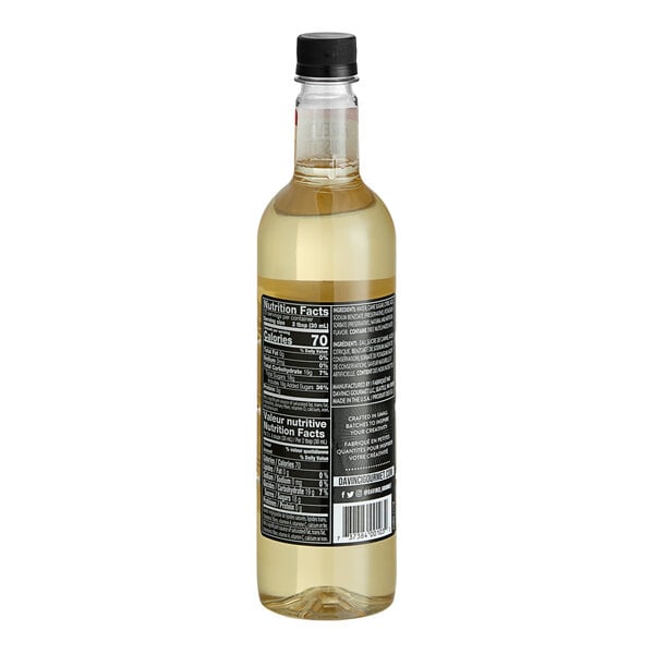A clear glass bottle of DaVinci Gourmet Classic Hazelnut Flavoring Syrup with a black cap and nutrition label visible.