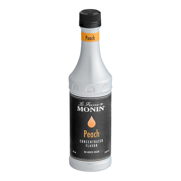 A bottle of Monin Peach Concentrated Flavor, 375 mL size.