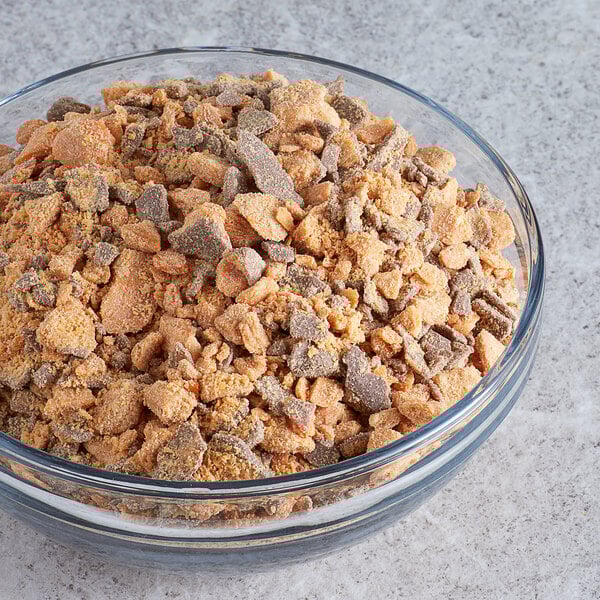 A bowl of food on a table with 3 lb. of BUTTERFINGER® pieces.