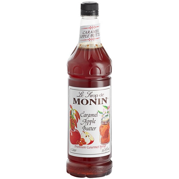 A Monin bottle of Caramel Apple Butter syrup with a white label.