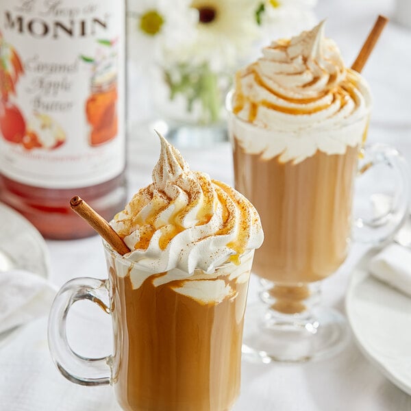 A glass mug of coffee with whipped cream and Monin caramel apple butter syrup.