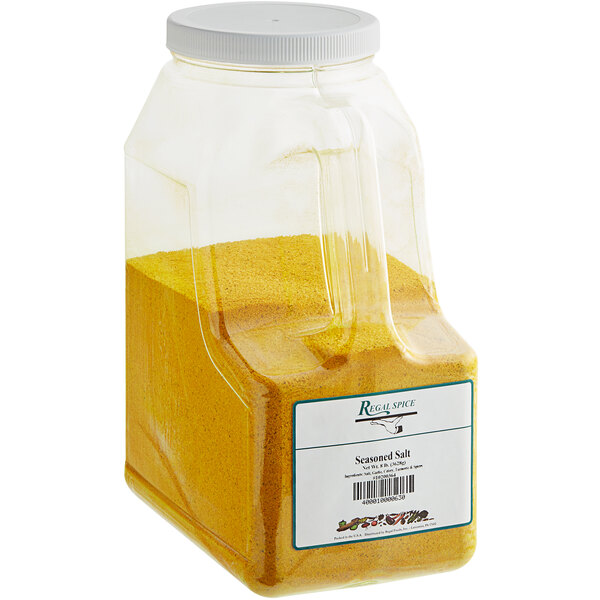 A plastic container of yellow seasoned salt.