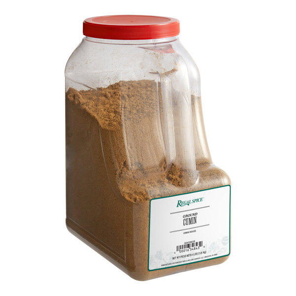 A plastic container of brown powder labeled "Regal Ground Cumin"