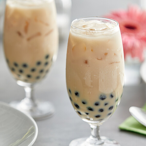 A pair of glasses of bubble tea made with Fanale Wintermelon Concentrated Syrup on a white plate.