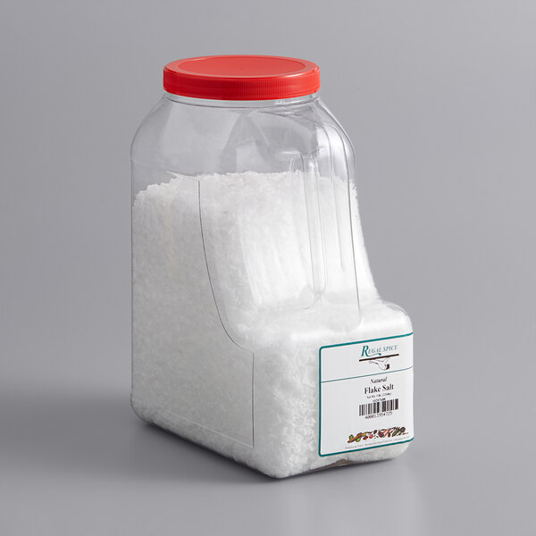 A plastic container of Regal Spanish sea salt flakes.