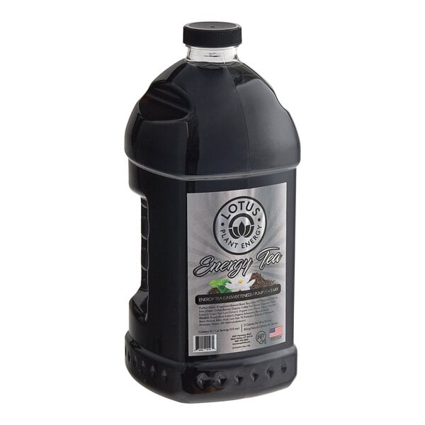 A black plastic container of Lotus Plant Energy Unsweetened Tea Concentrate with a label.
