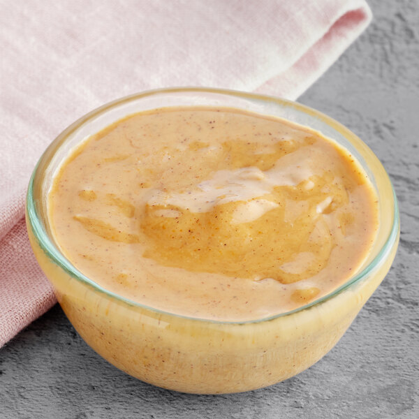 A bowl of American Almond hazelnut paste on a table.