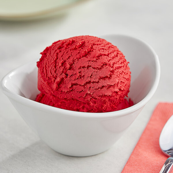 A bowl of I. Rice strawberry hard serve ice cream with a spoon on a white background.