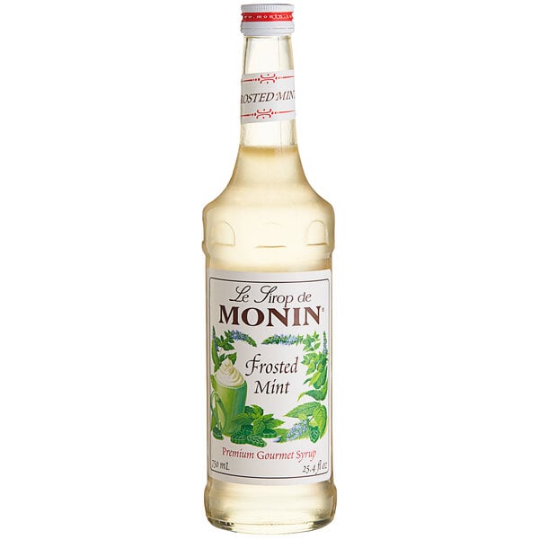 A bottle of Monin Frosted Mint Syrup with a label.