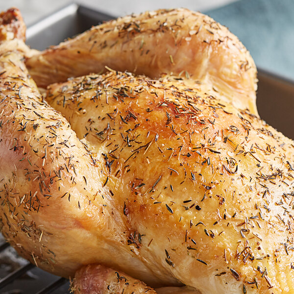 A whole roasted chicken with Regal Spanish thyme leaves sprinkled on top.