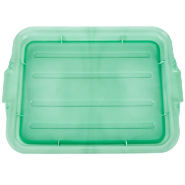 A green Vollrath Traex plastic lid with raised lines and handles.