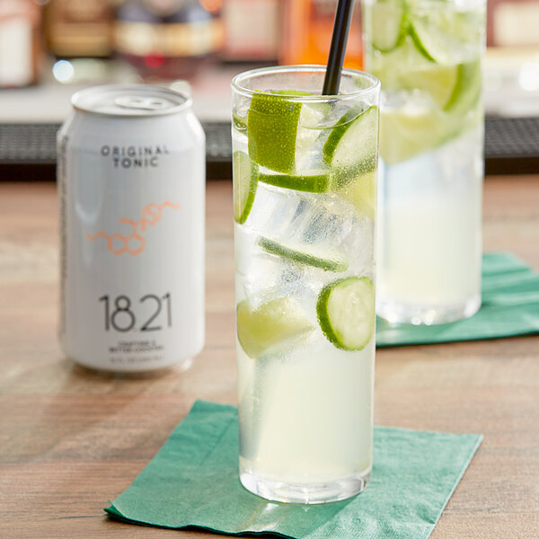 A glass of 18.21 Bitters tonic with ice and lime slices.