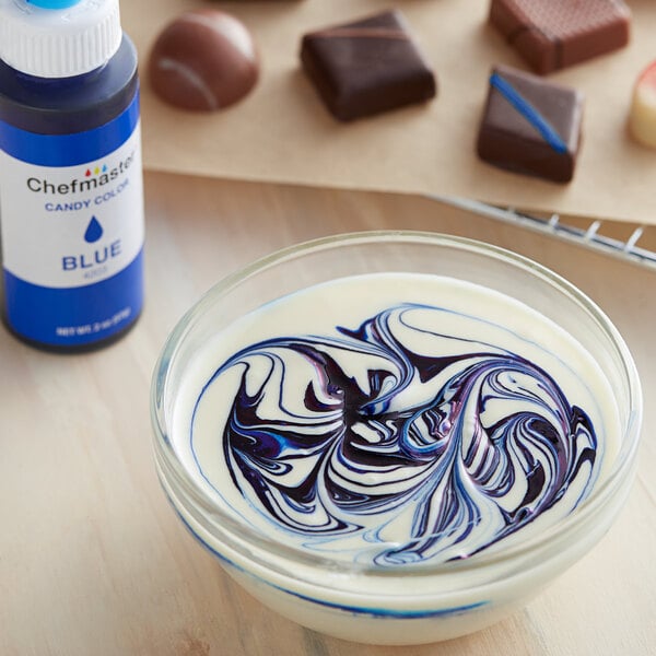 A bowl of white liquid with blue swirls.