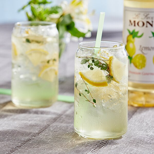 A glass of lemonade with a straw on a white background.