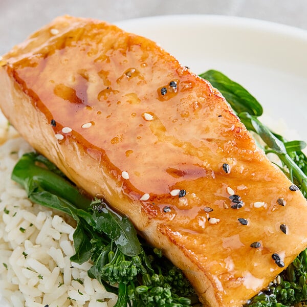 A plate of food with rice and fish topped with Monin Yuzu Fruit Puree.