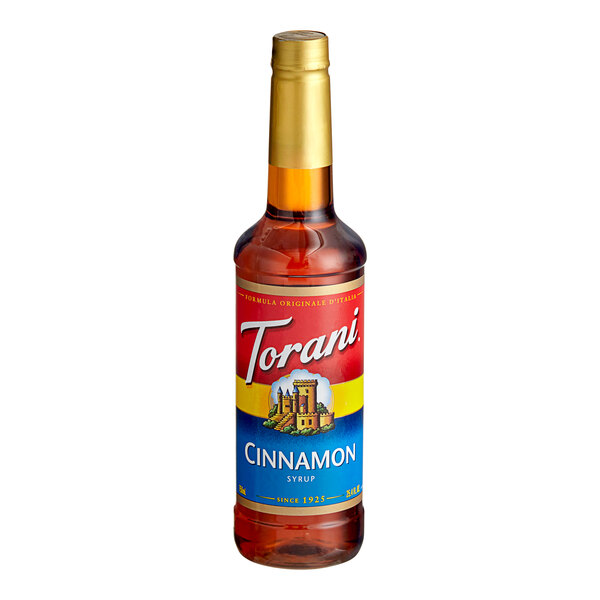 A Torani plastic bottle of cinnamon flavoring syrup with a red label.