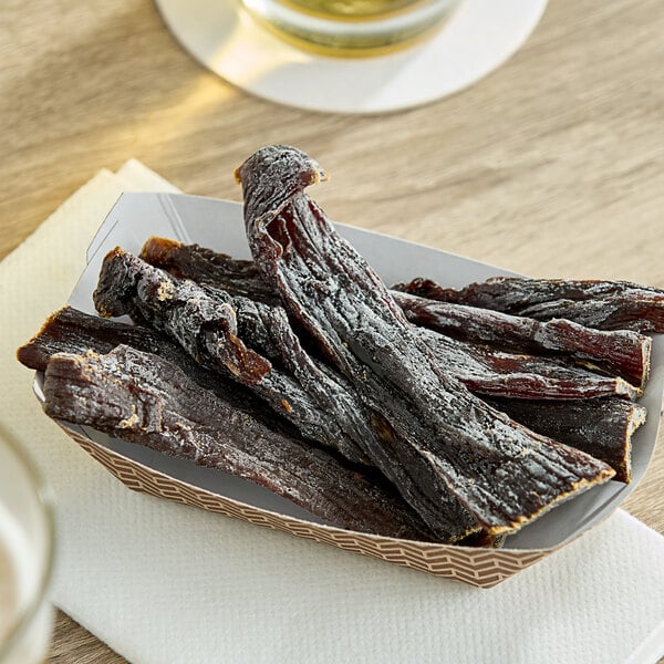 A table with a basket of Wild Bill's hickory-smoked beef jerky and a bowl of meat.