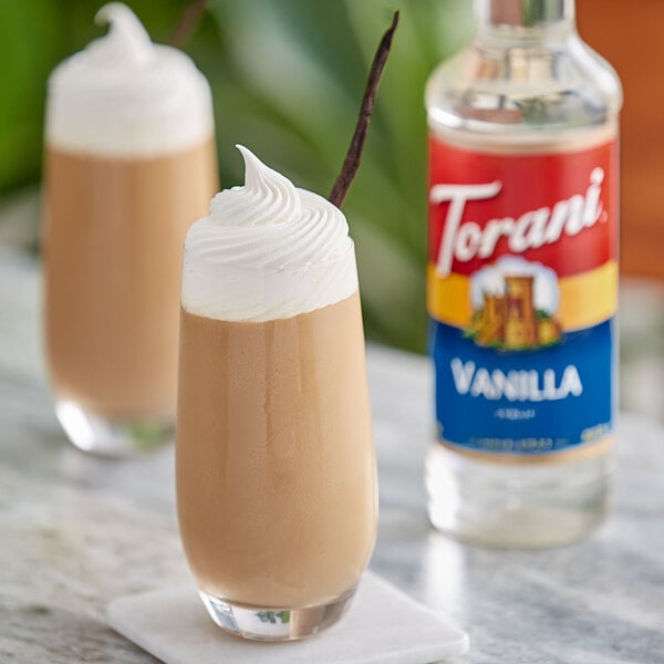 Two glasses of vanilla milkshakes with Torani Vanilla syrup on top.